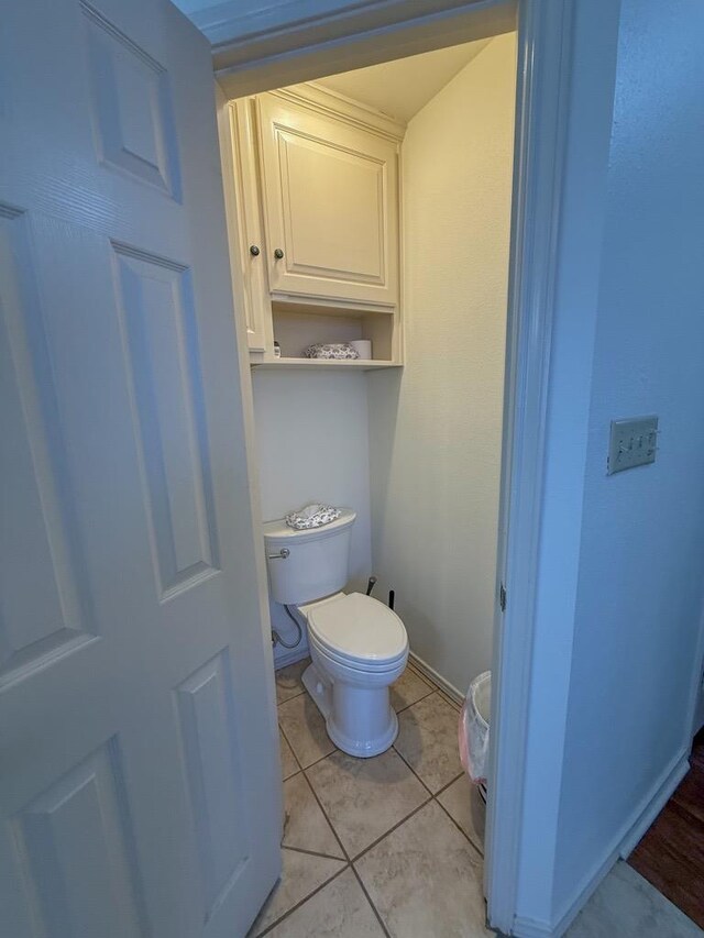 bathroom with tile patterned flooring and toilet