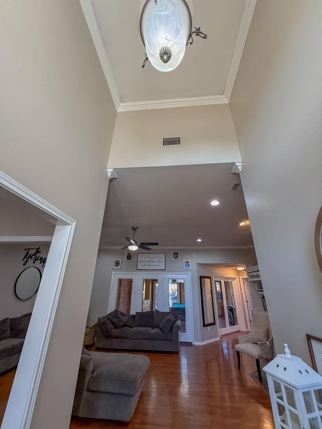 living room featuring ornamental molding, ceiling fan, and dark hardwood / wood-style flooring