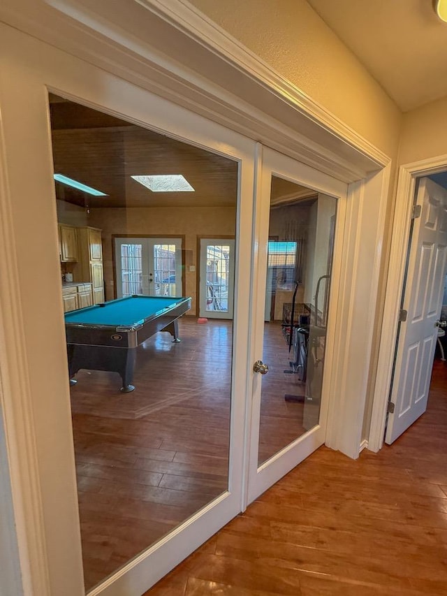 rec room with hardwood / wood-style floors, billiards, and french doors