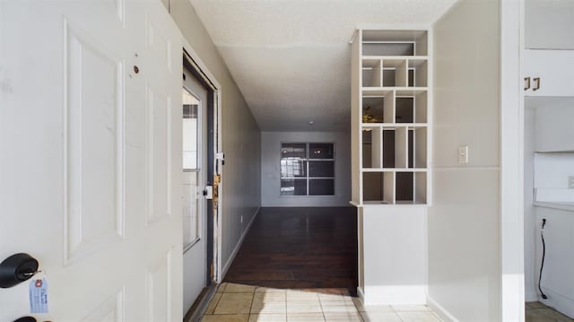 interior space with tile patterned flooring and a textured ceiling