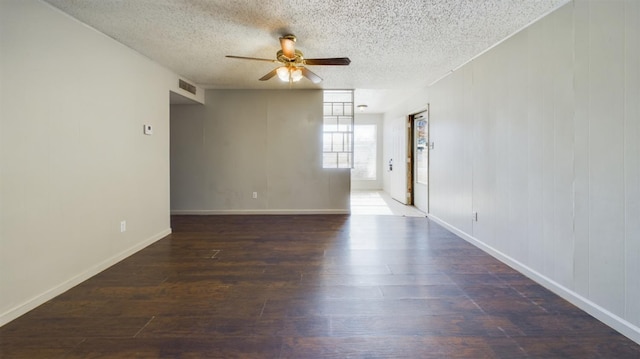 unfurnished room featuring a textured ceiling, dark wood-type flooring, and ceiling fan