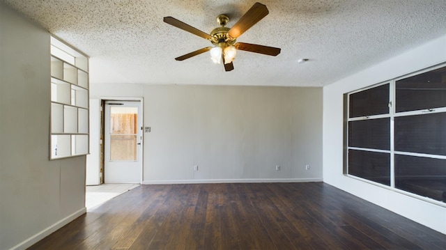 empty room with ceiling fan, wood-type flooring, and a textured ceiling