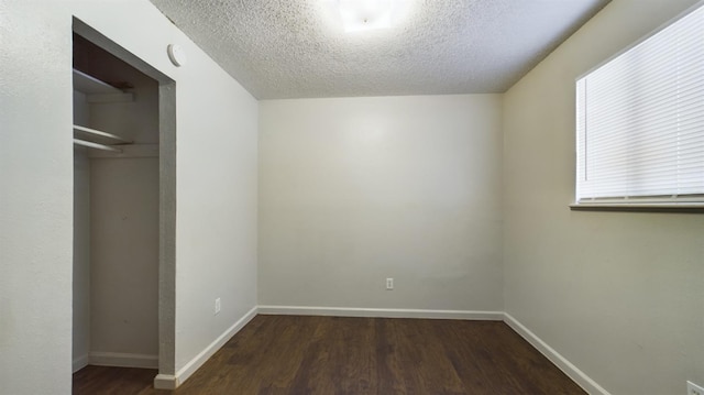 unfurnished bedroom with a closet, dark hardwood / wood-style floors, and a textured ceiling