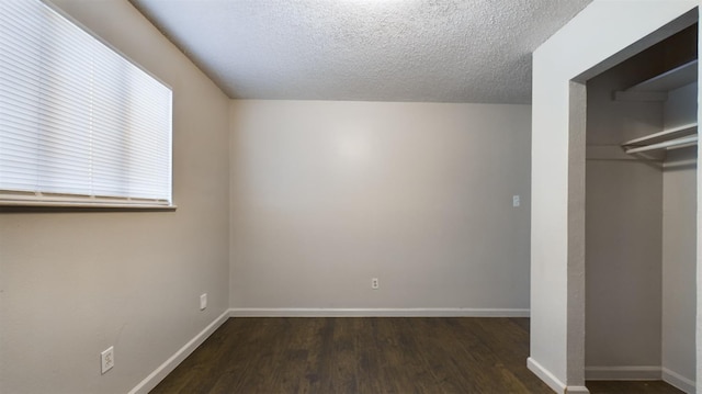 unfurnished bedroom with dark wood-type flooring, a closet, and a textured ceiling