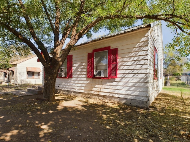 view of side of property featuring fence