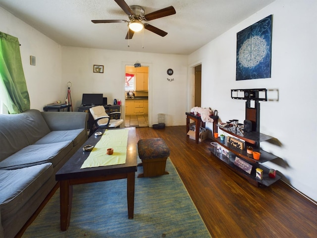 living room with ceiling fan and wood finished floors