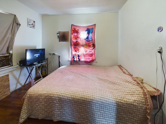 bedroom featuring baseboards and wood finished floors