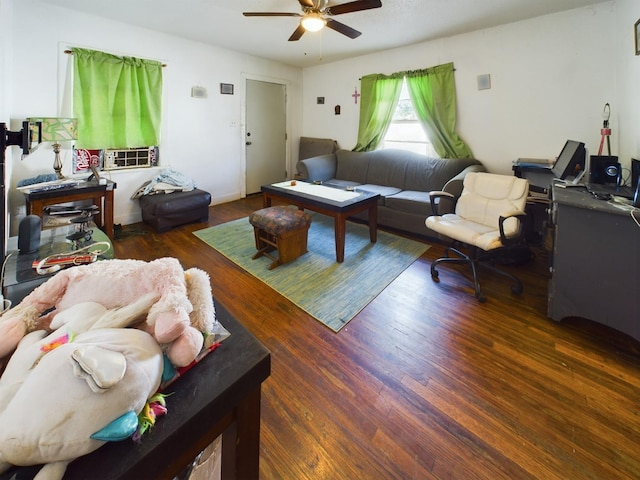 living area featuring a ceiling fan and wood finished floors