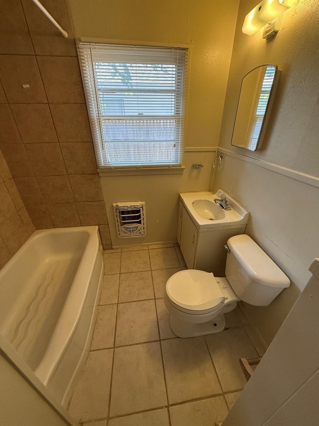 full bathroom with washtub / shower combination, tile patterned floors, toilet, heating unit, and vanity