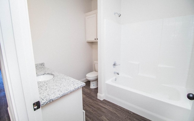 full bathroom featuring vanity, hardwood / wood-style flooring, shower / tub combination, and toilet