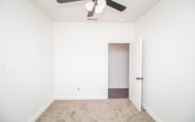 unfurnished room with ceiling fan and light carpet