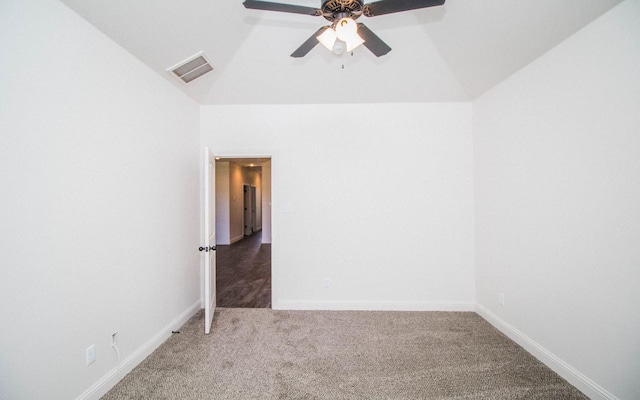 carpeted empty room with vaulted ceiling and ceiling fan