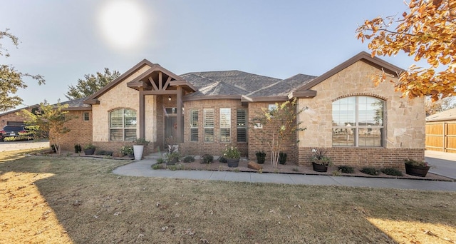 french country inspired facade with a front yard