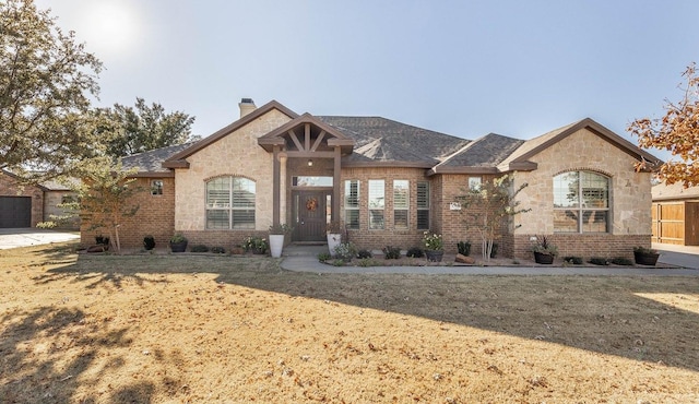 view of front facade with a garage and a front lawn