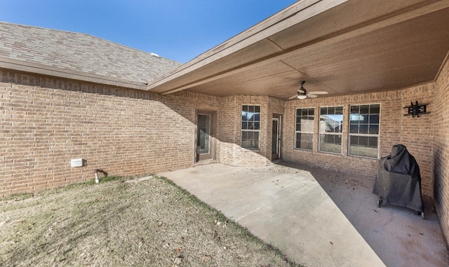 view of patio with area for grilling and ceiling fan