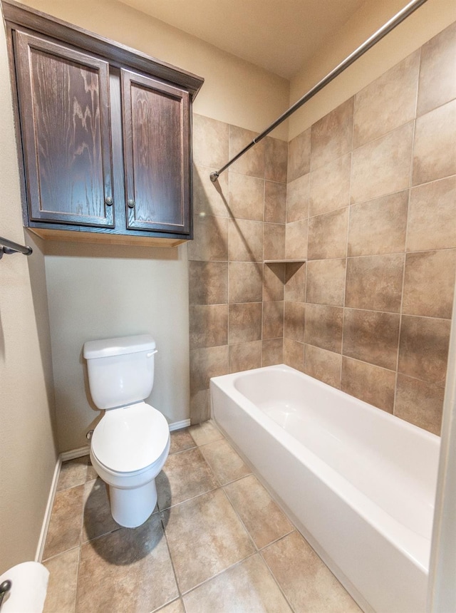 bathroom with tile patterned flooring, tiled shower / bath combo, and toilet