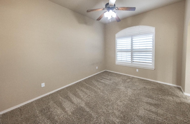 carpeted spare room featuring ceiling fan