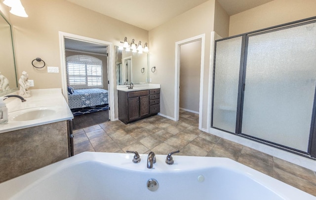 bathroom with vanity and shower with separate bathtub