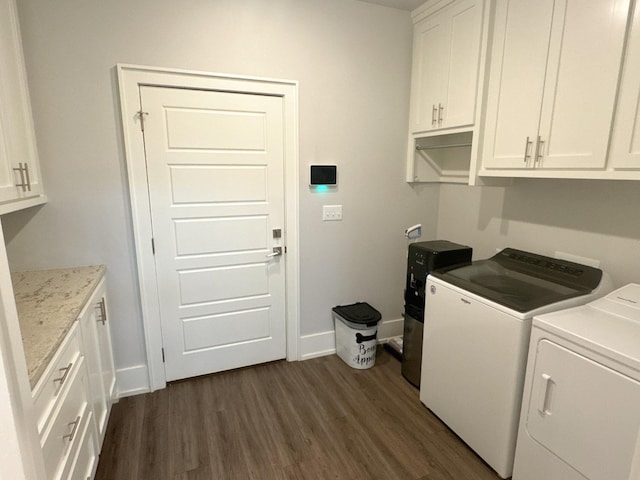 washroom featuring cabinets, separate washer and dryer, and dark hardwood / wood-style floors