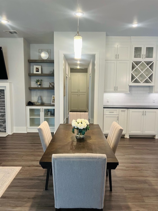 dining space with dark wood-type flooring