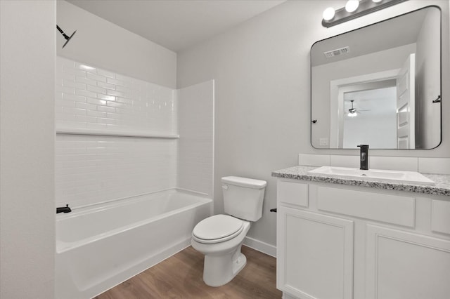 7429 30th St, Lubbock, TX 79407 - full bathroom featuring vanity, toilet, bathing tub / shower combination, and hardwood / wood-style floors