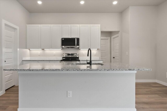 7429 30th St, Lubbock, TX 79407 - kitchen with white cabinetry, stainless steel appliances, and a center island with sink