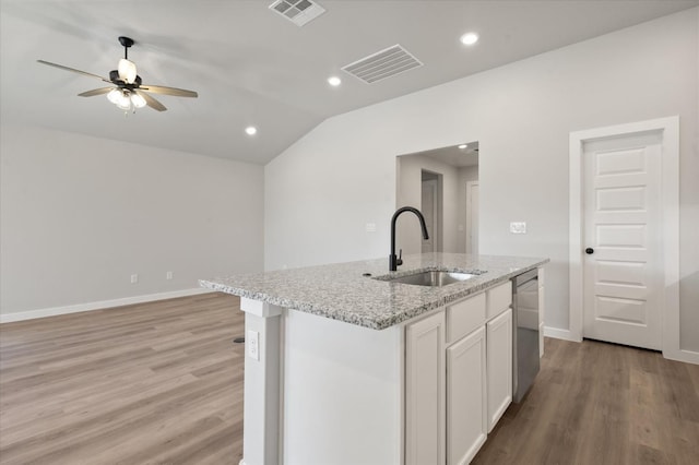7429 30th St, Lubbock, TX 79407 - kitchen with sink, light stone counters, an island with sink, white cabinets, and stainless steel dishwasher