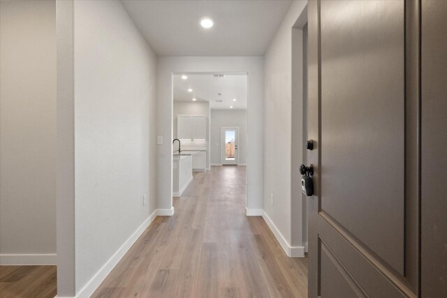 7429 30th St, Lubbock, TX 79407 - hallway featuring sink and light wood-type flooring
