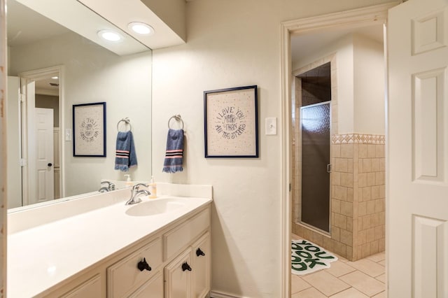 bathroom featuring an enclosed shower, vanity, and tile patterned floors