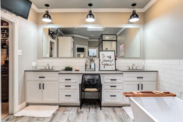 bathroom featuring ornamental molding, vanity, and hardwood / wood-style floors