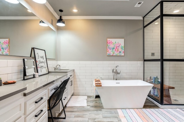 bathroom with ornamental molding, tile walls, and vanity