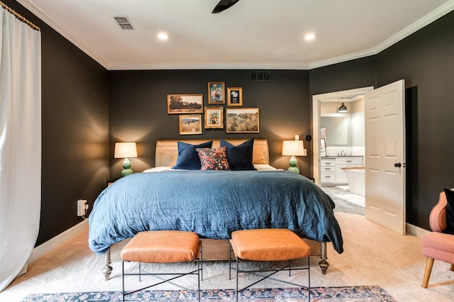 bedroom featuring light carpet, ornamental molding, and ensuite bathroom