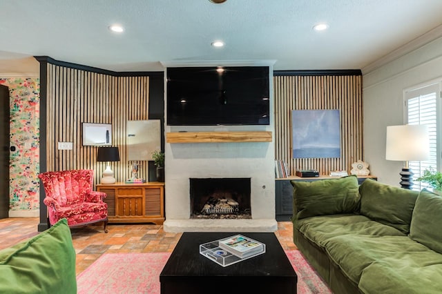 living room featuring crown molding and a fireplace