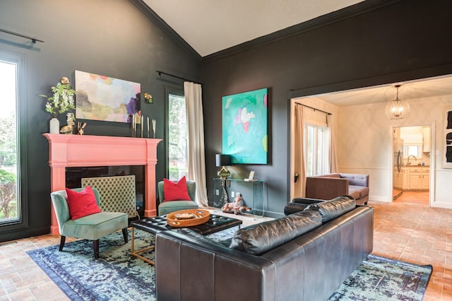 living room with a premium fireplace, lofted ceiling, sink, and a wealth of natural light