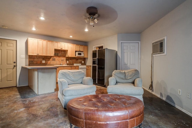 living area featuring a wall mounted air conditioner and ceiling fan