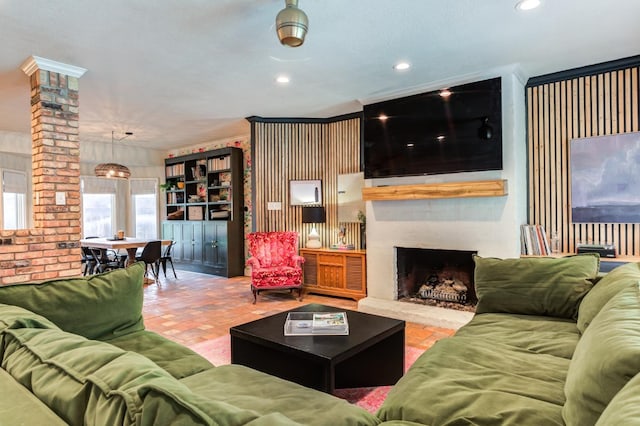 living room featuring a fireplace and ornate columns