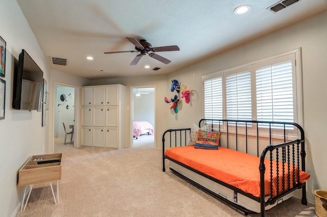 carpeted bedroom with ceiling fan and a closet