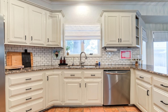 kitchen with sink, tasteful backsplash, light stone countertops, white cabinets, and stainless steel dishwasher