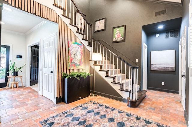 staircase featuring ornamental molding