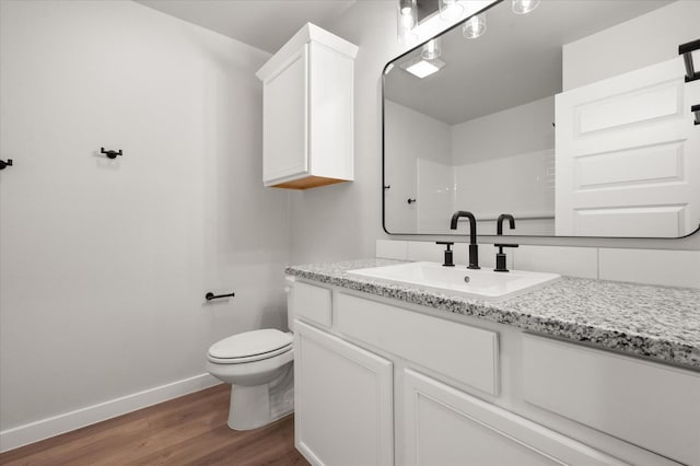 6811 54th St, Lubbock, TX 79407 - bathroom with hardwood / wood-style flooring, vanity, toilet, and a shower