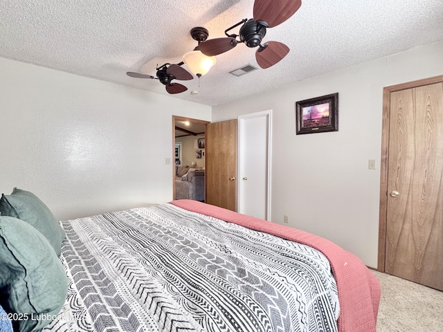 914 W Lee St, Floydada, TX 79235 - bedroom with a textured ceiling, ceiling fan, and carpet floors