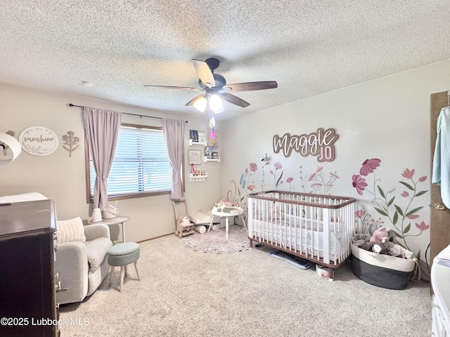 914 W Lee St, Floydada, TX 79235 - carpeted bedroom with a crib, a ceiling fan, and a textured ceiling