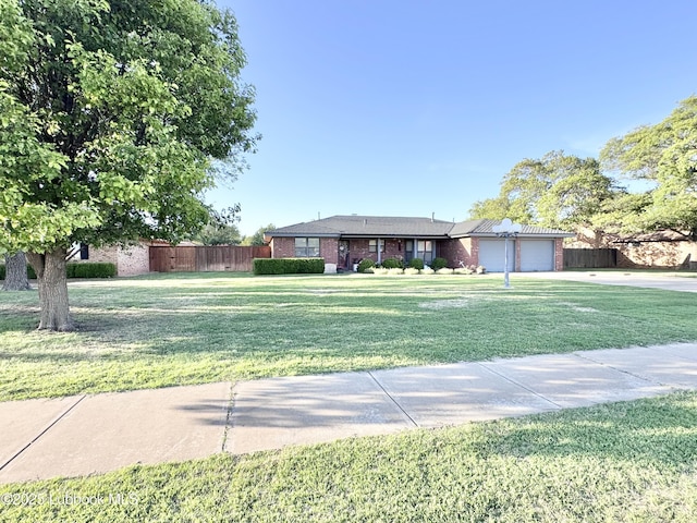 914 W Lee St, Floydada, TX 79235 - ranch-style house with a garage, brick siding, and driveway