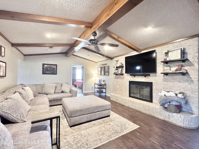 914 W Lee St, Floydada, TX 79235 - living area with a textured ceiling, wood finished floors, a brick fireplace, and a ceiling fan