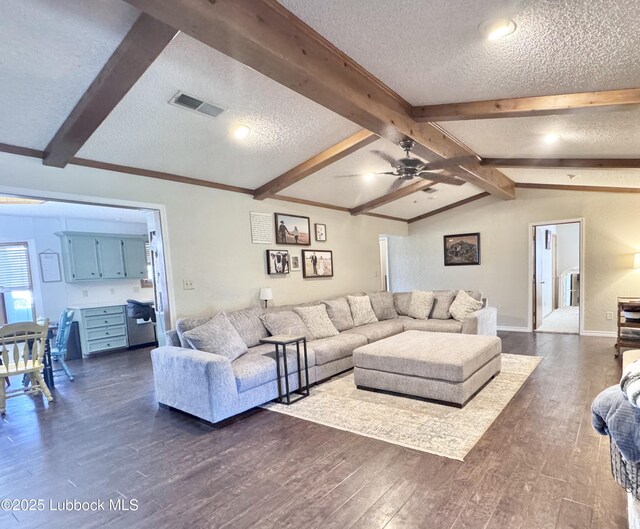 914 W Lee St, Floydada, TX 79235 - living room with a textured ceiling, dark wood-type flooring, and a ceiling fan