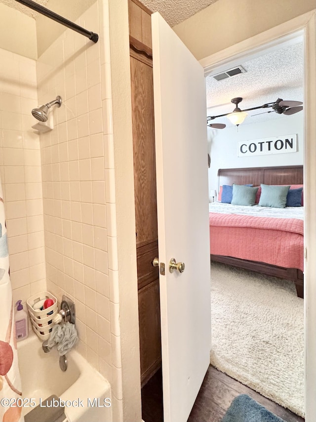 914 W Lee St, Floydada, TX 79235 - full bath with connected bathroom, a textured ceiling, and shower / tub combo