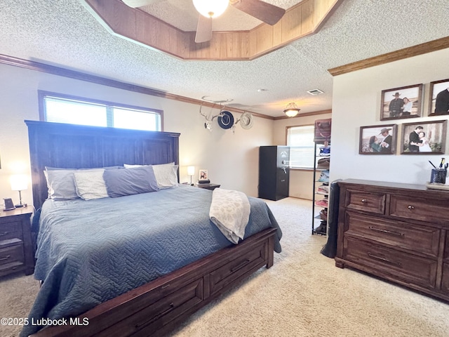 914 W Lee St, Floydada, TX 79235 - bedroom featuring a textured ceiling, light colored carpet, multiple windows, ornamental molding, and ceiling fan