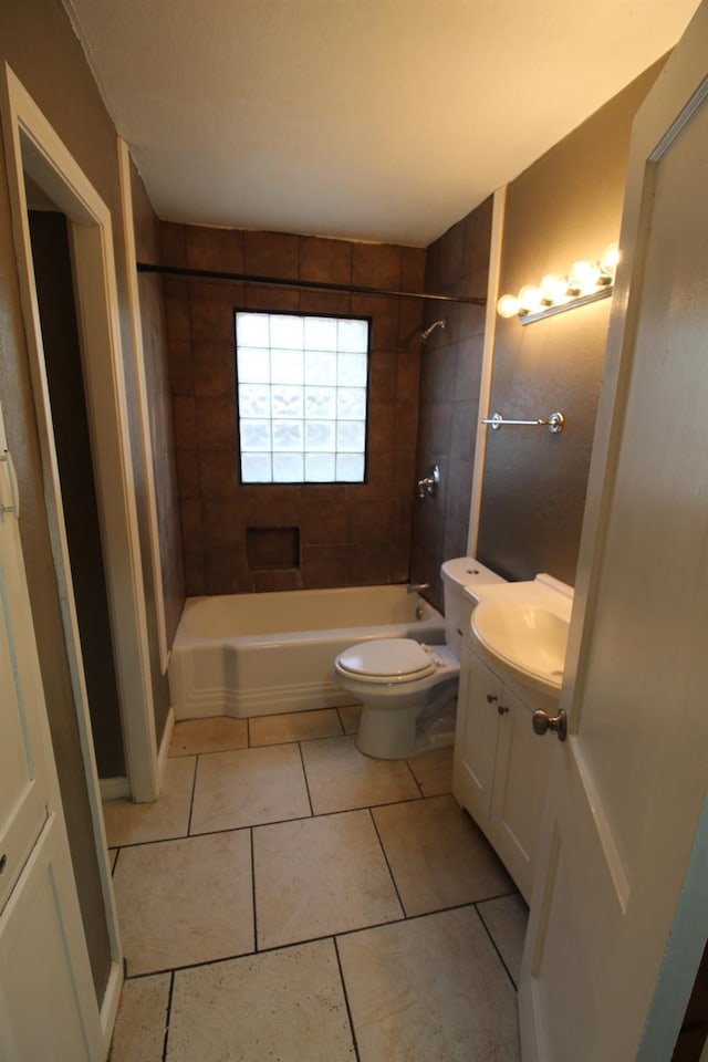 full bathroom featuring vanity, tiled shower / bath, tile patterned floors, and toilet