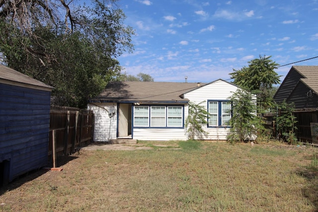 rear view of property with a lawn