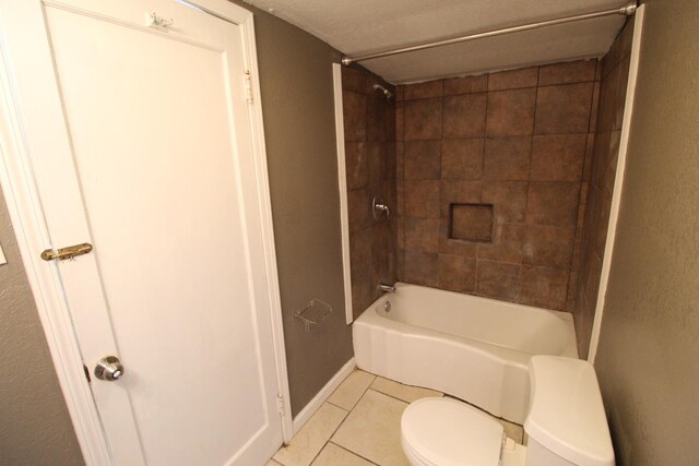 bathroom with tile patterned floors, toilet, and tiled shower / bath